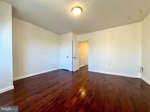 spare room featuring dark hardwood / wood-style flooring