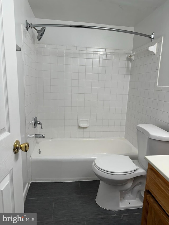 full bathroom with vanity, toilet, tile patterned flooring, and tiled shower / bath combo