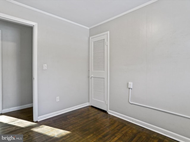 unfurnished bedroom featuring crown molding and dark hardwood / wood-style floors