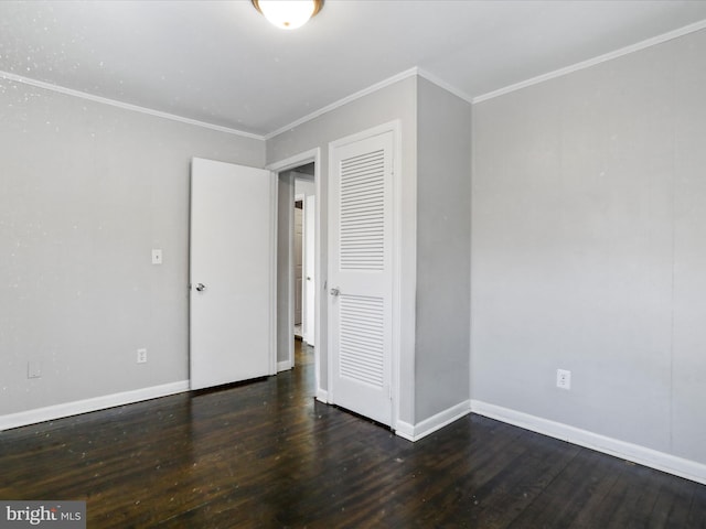 unfurnished bedroom featuring ornamental molding, a closet, and dark hardwood / wood-style floors