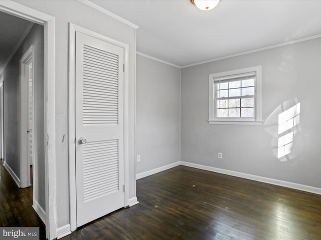 unfurnished bedroom featuring ornamental molding and dark hardwood / wood-style floors