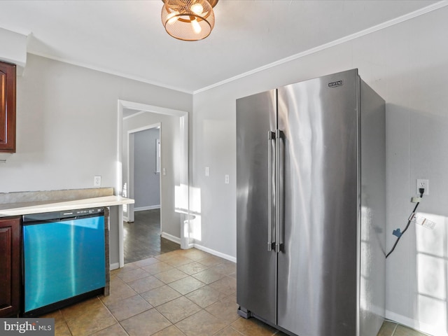 kitchen with stainless steel appliances, light tile patterned floors, and crown molding