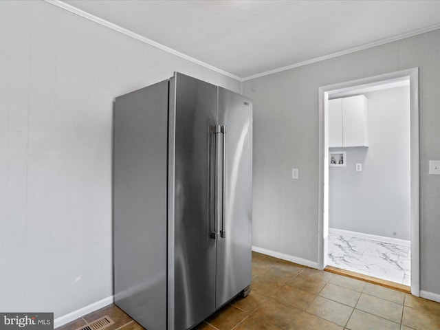 interior space featuring tile patterned flooring, crown molding, and high end fridge