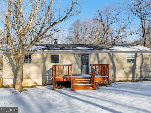 snow covered property featuring a deck