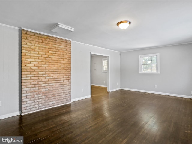 unfurnished room with ornamental molding and dark wood-type flooring