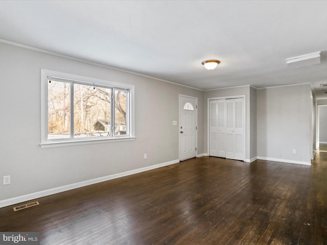 foyer featuring crown molding and dark hardwood / wood-style floors