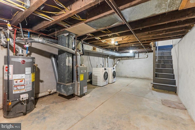 basement featuring independent washer and dryer, heating unit, and gas water heater