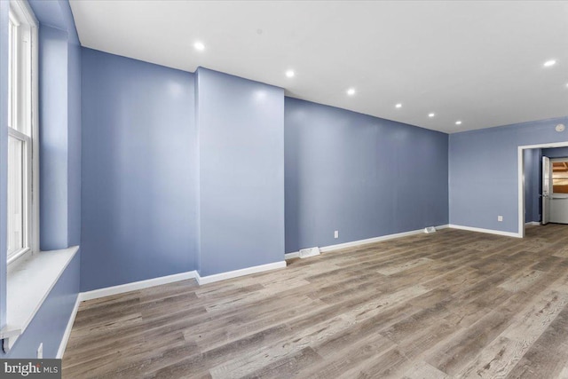 unfurnished room with hardwood / wood-style flooring