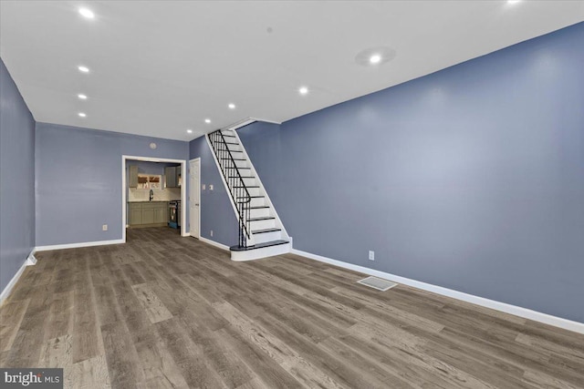 unfurnished living room with wood-type flooring