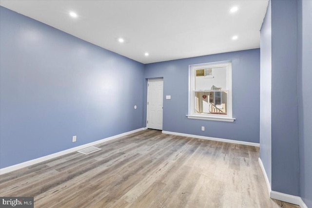 spare room with light hardwood / wood-style flooring