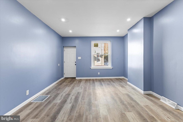 empty room with light hardwood / wood-style flooring