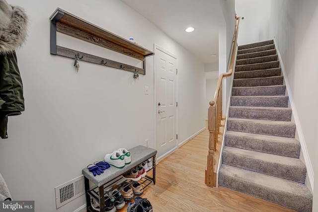 staircase featuring hardwood / wood-style flooring