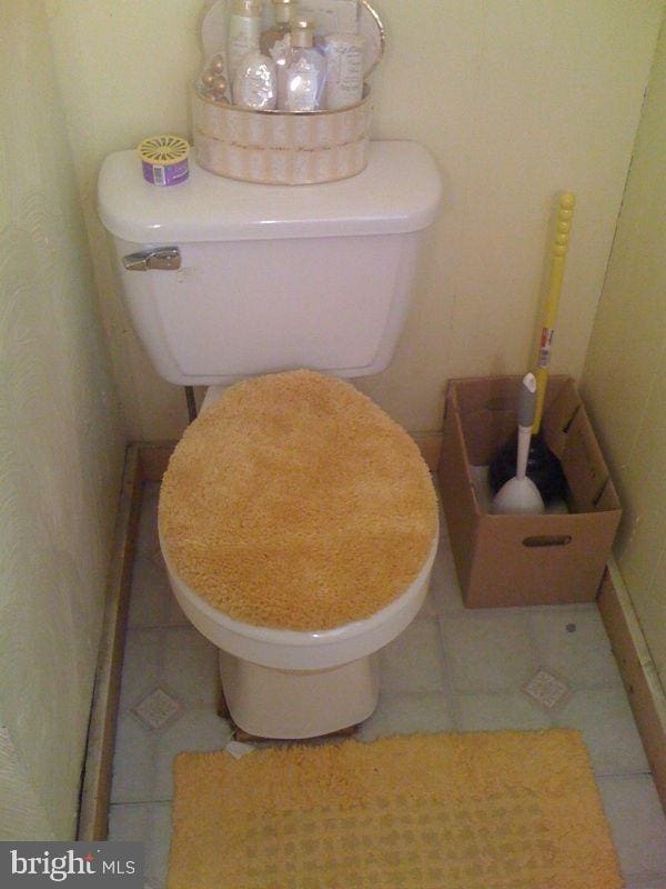 bathroom with tile patterned flooring and toilet