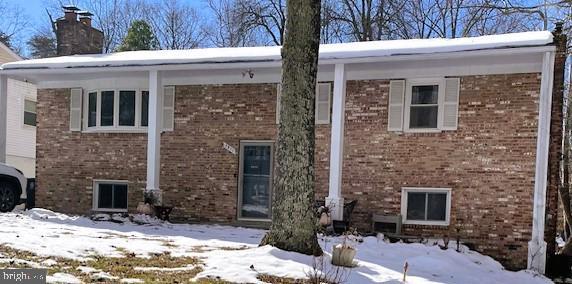 view of snow covered rear of property