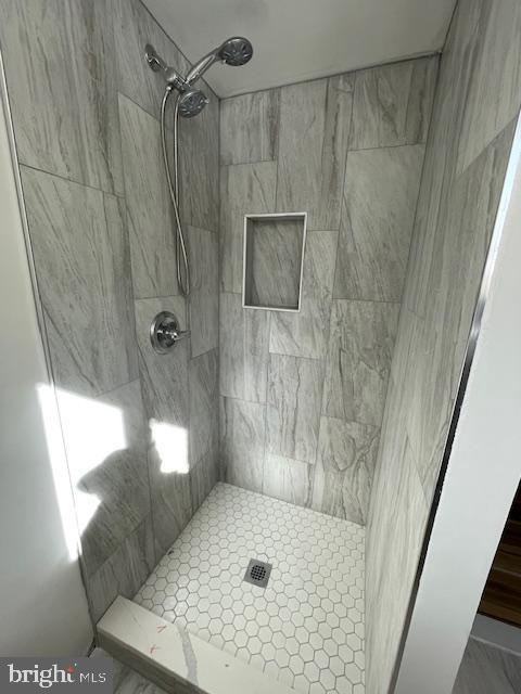 bathroom with a tile shower