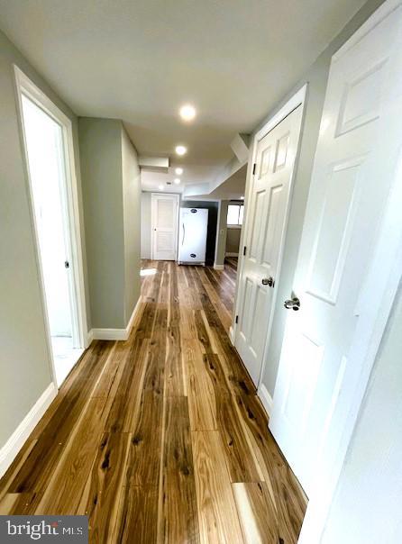 hall with hardwood / wood-style flooring