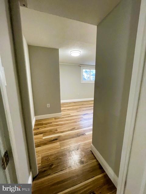 hallway with hardwood / wood-style flooring