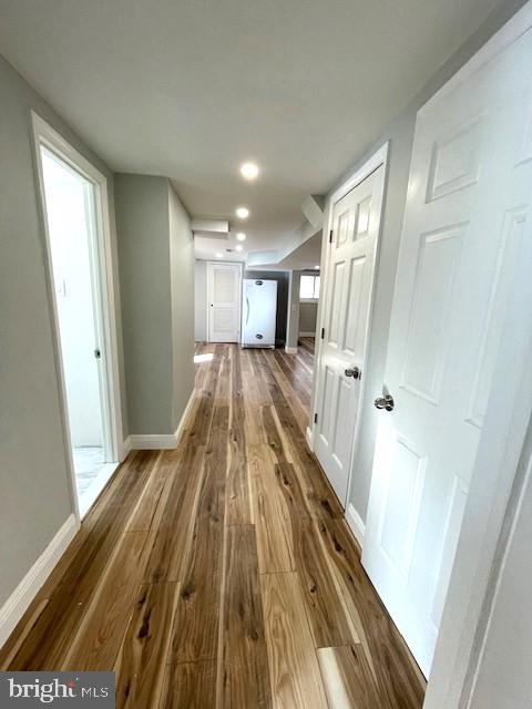 hall with dark hardwood / wood-style flooring