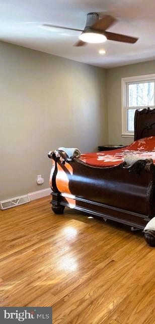 bedroom featuring ceiling fan and light hardwood / wood-style floors