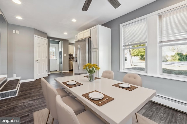 dining space featuring ceiling fan, a baseboard heating unit, and dark hardwood / wood-style flooring