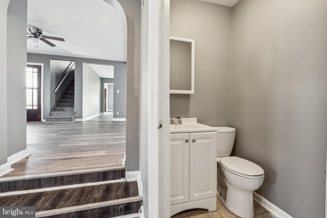 bathroom featuring ceiling fan, vanity, and toilet