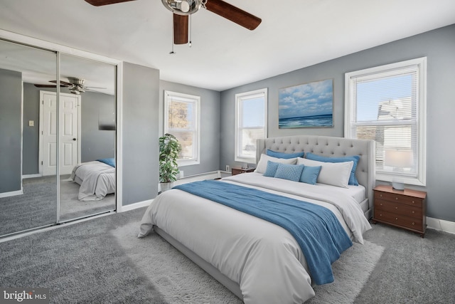 carpeted bedroom featuring ceiling fan and a closet