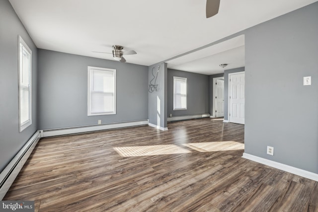 unfurnished room with ceiling fan, dark hardwood / wood-style floors, and a baseboard radiator