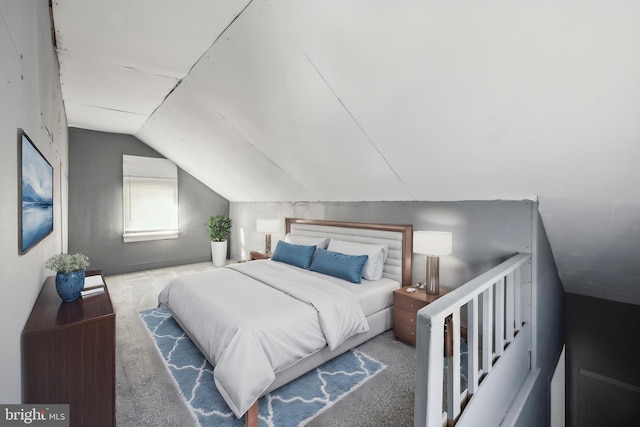 carpeted bedroom featuring lofted ceiling