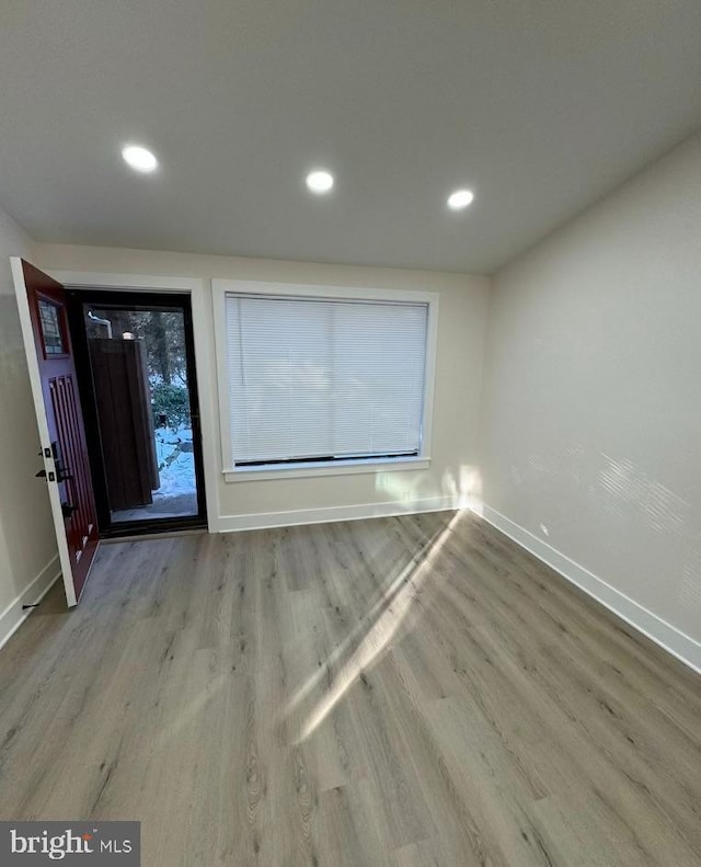 empty room with light hardwood / wood-style floors