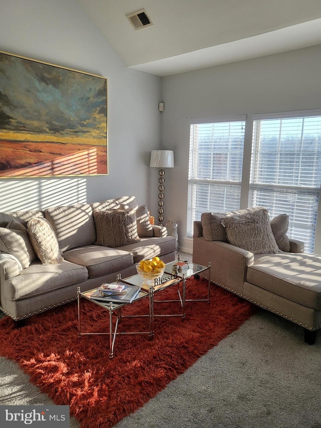 living room with lofted ceiling and carpet floors