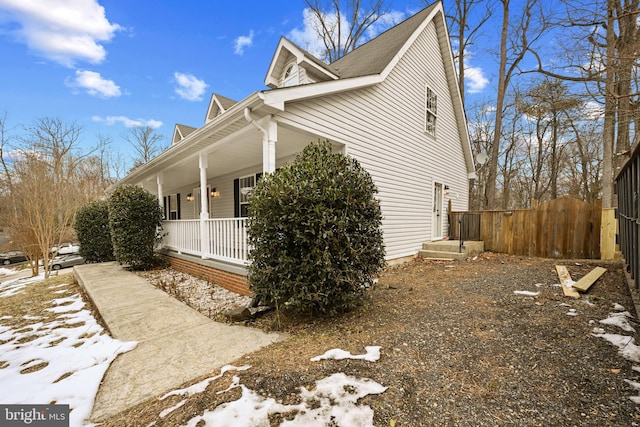 view of snowy exterior with a porch