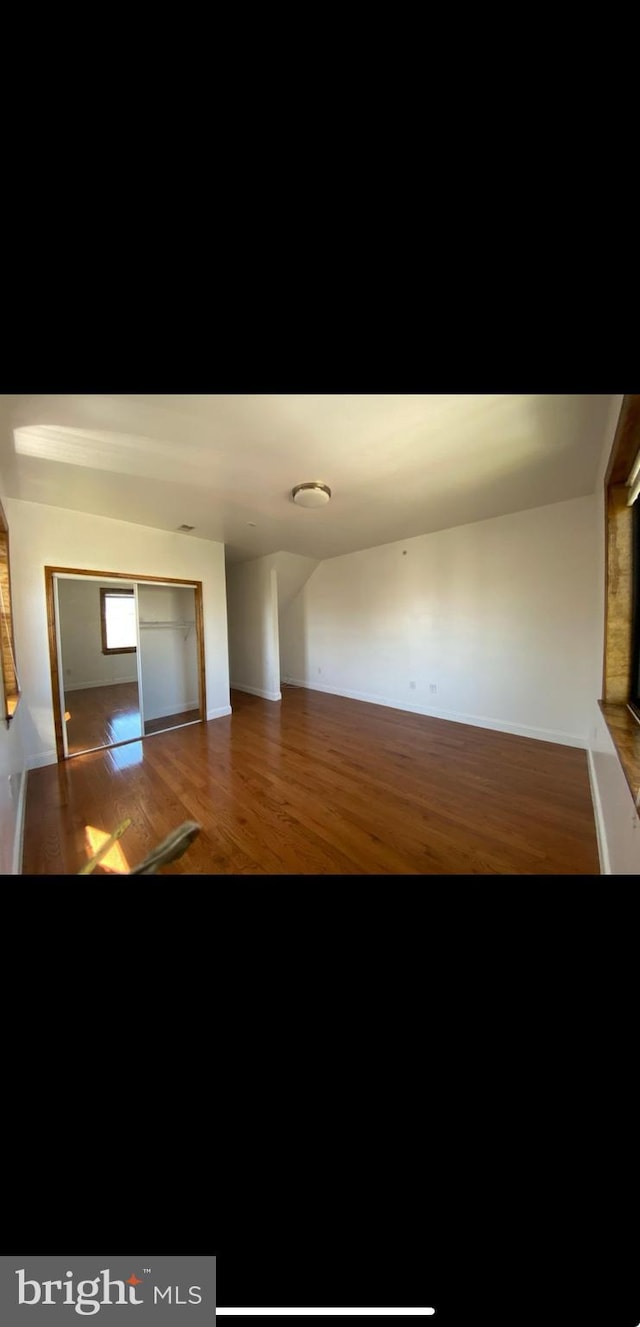 unfurnished living room featuring hardwood / wood-style floors