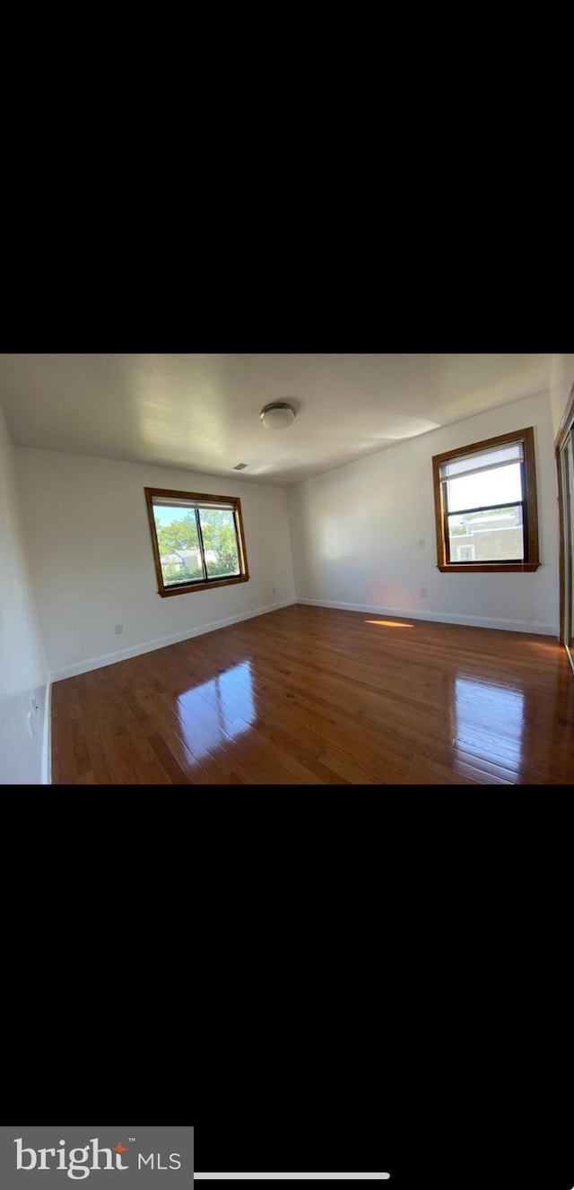 empty room with wood-type flooring