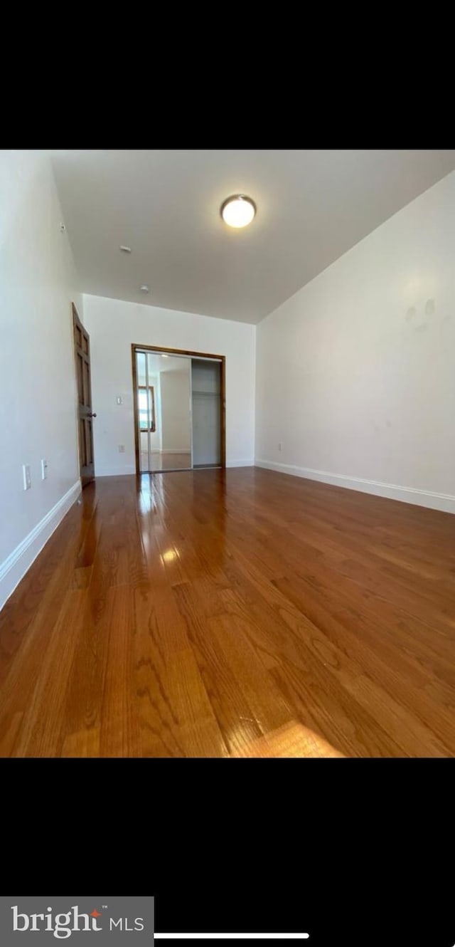 empty room with hardwood / wood-style floors