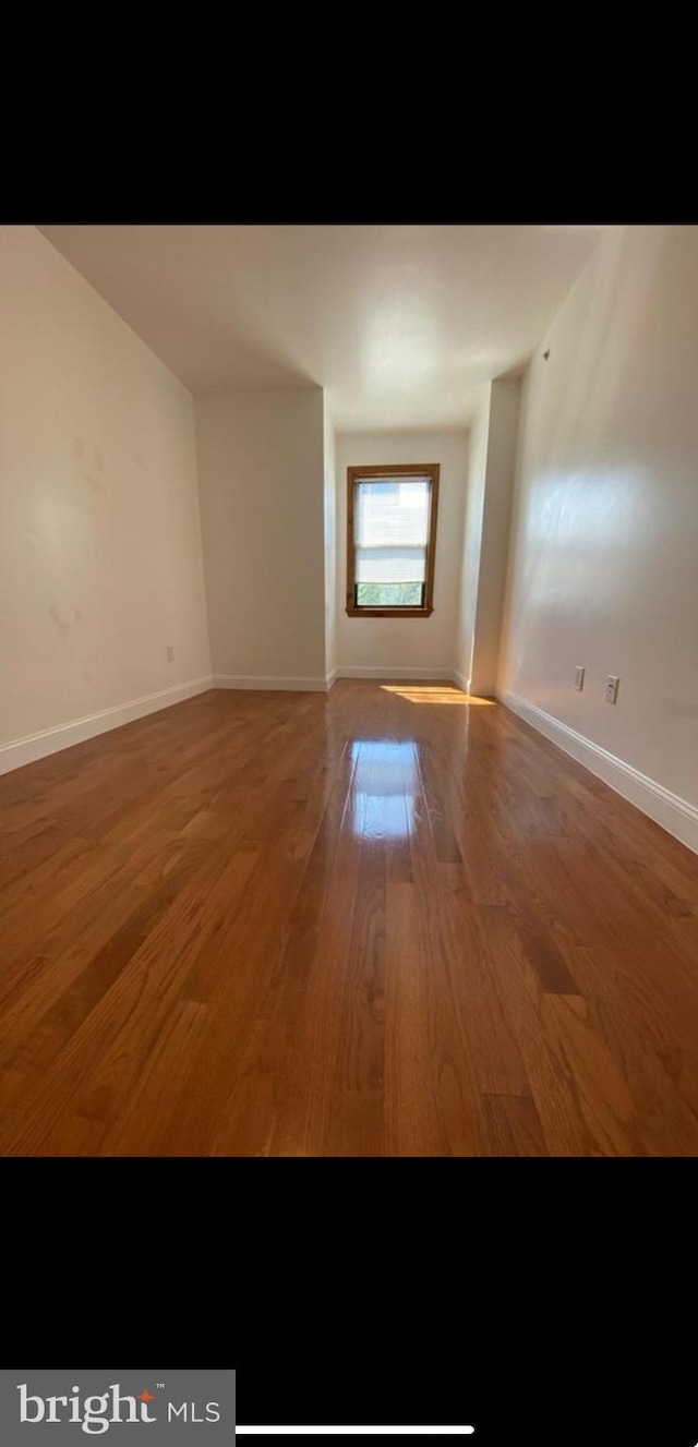 empty room with dark wood-type flooring