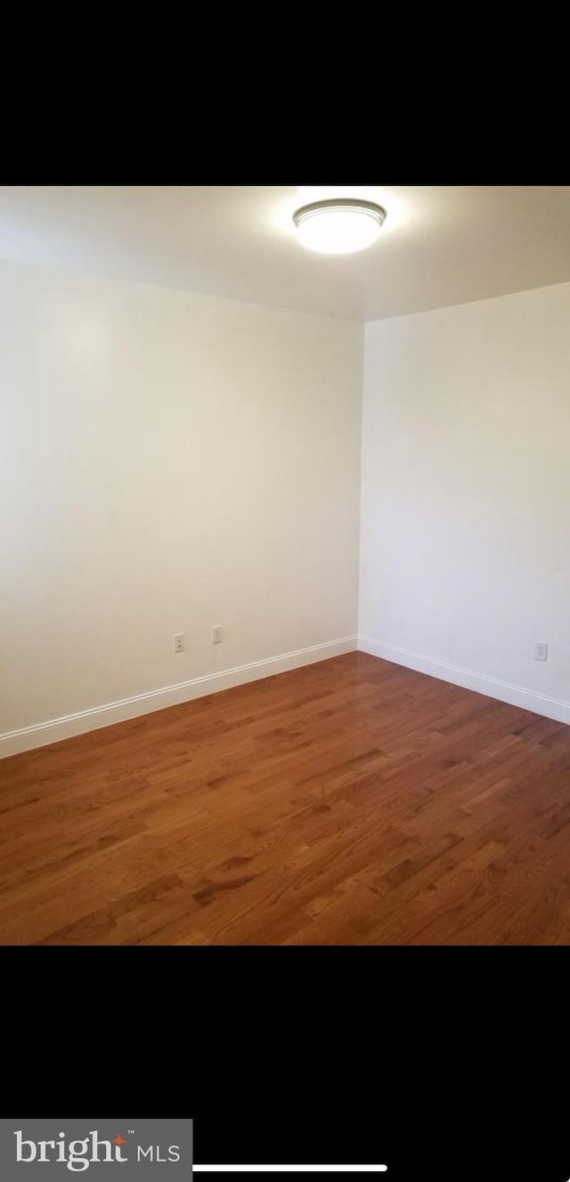 spare room featuring dark hardwood / wood-style flooring