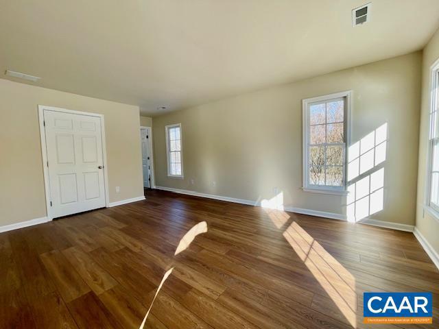 unfurnished room featuring dark hardwood / wood-style floors