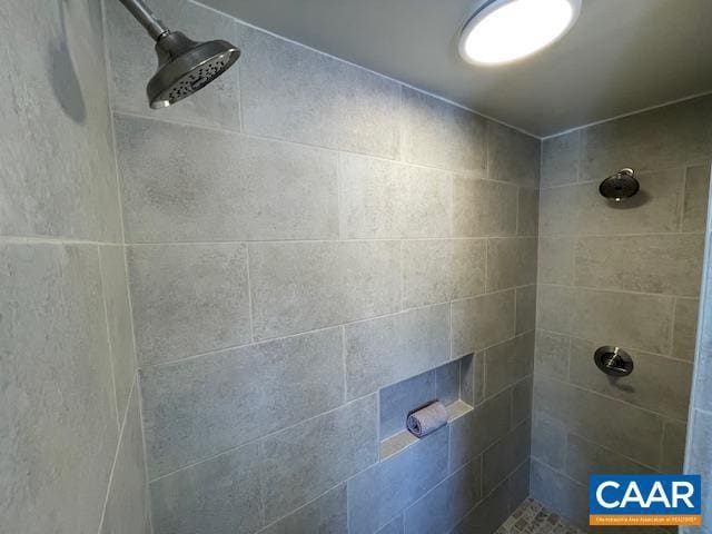 bathroom with tiled shower