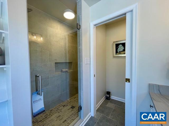 bathroom with a shower with door