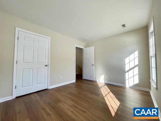 unfurnished room featuring dark hardwood / wood-style flooring