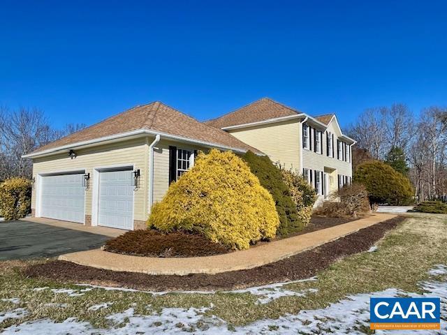 snow covered property featuring a garage