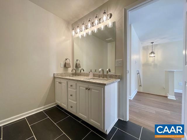 bathroom with tile patterned floors and vanity