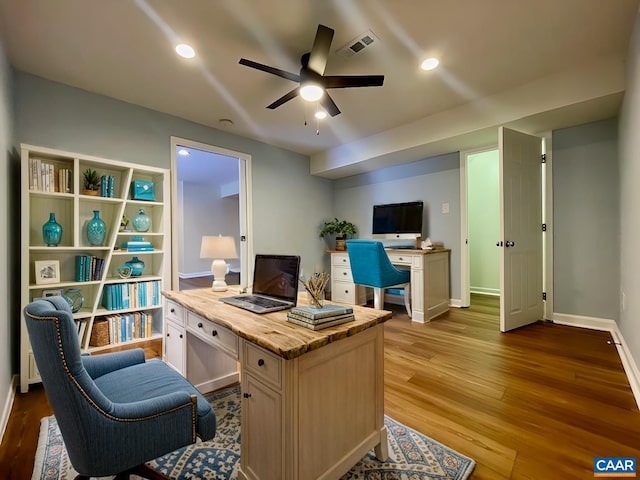 home office with ceiling fan and light hardwood / wood-style flooring