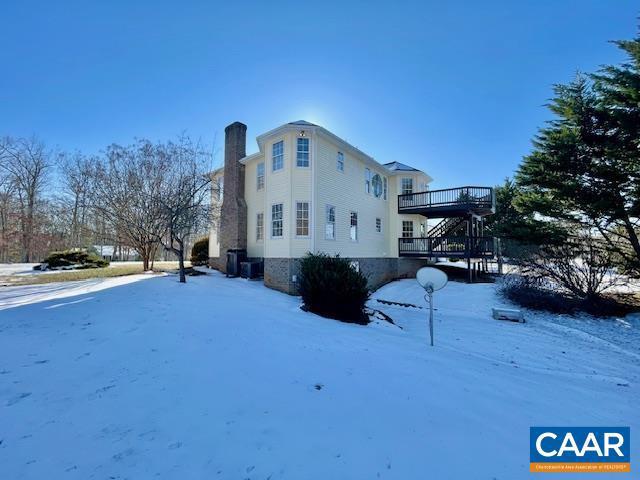 snow covered property featuring a wooden deck