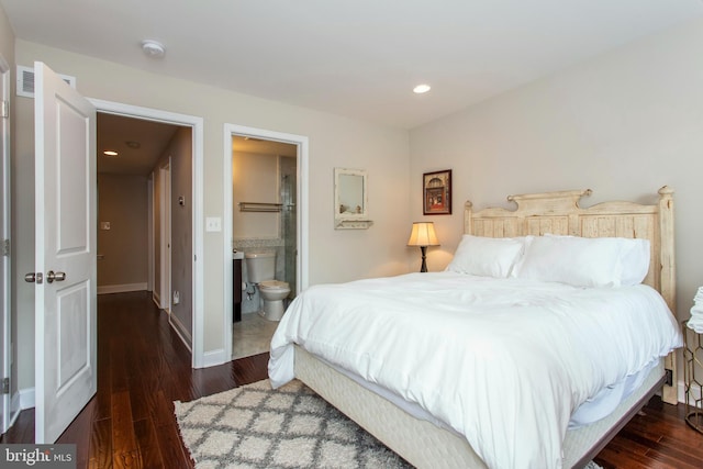 bedroom with dark hardwood / wood-style flooring and ensuite bathroom