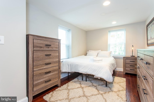 bedroom with dark wood-type flooring