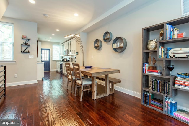 dining area with dark hardwood / wood-style flooring