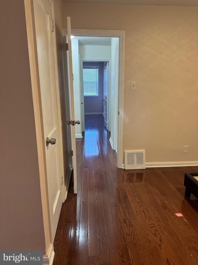 corridor featuring dark hardwood / wood-style floors