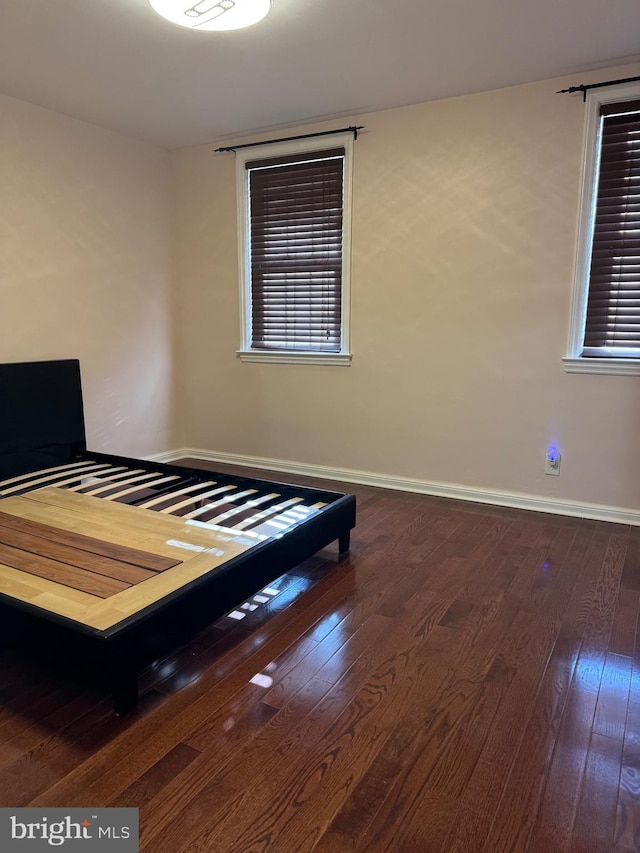 unfurnished bedroom featuring dark hardwood / wood-style flooring