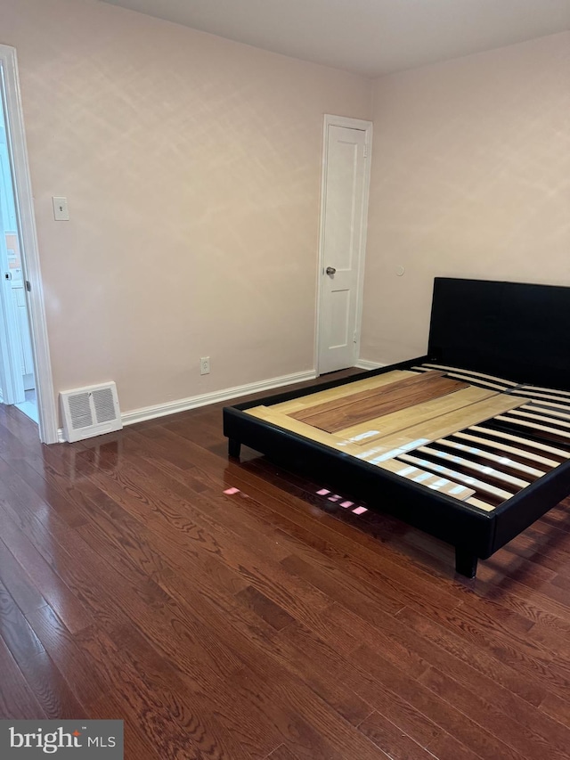 unfurnished bedroom featuring dark wood-type flooring